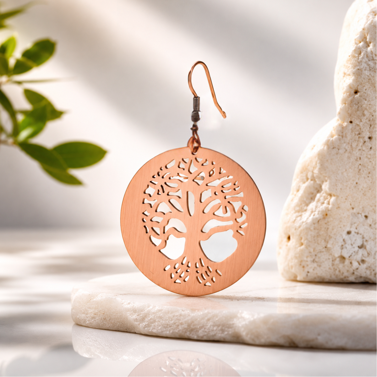copper earring with tree of life design embossed
